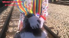 Clown almost gets hit by train while getting head